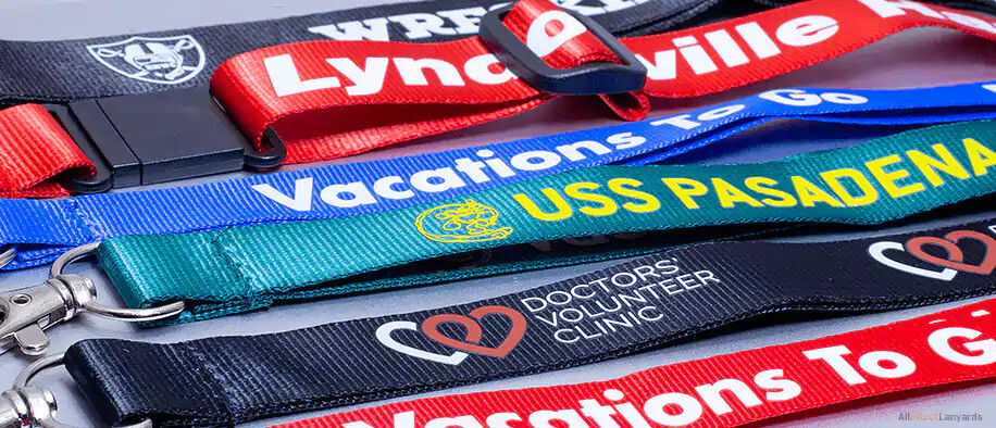 Glossy nylon lanyards in black, red, blue, teal and navy with white and yellow printing and buckles